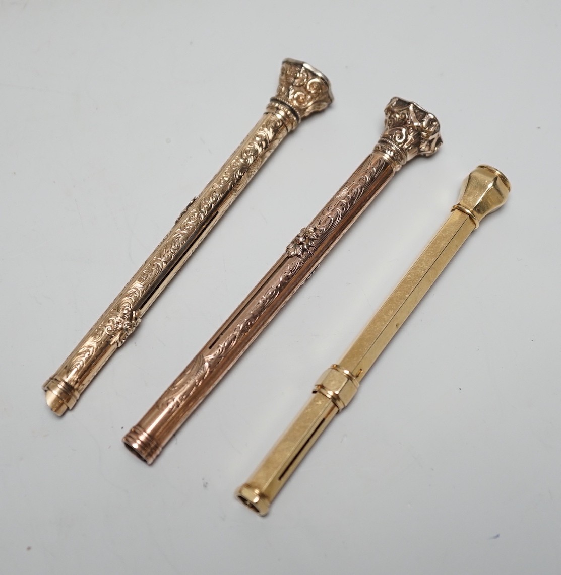 Three assorted yellow metal overlaid and gem set propelling pencils including Mordan